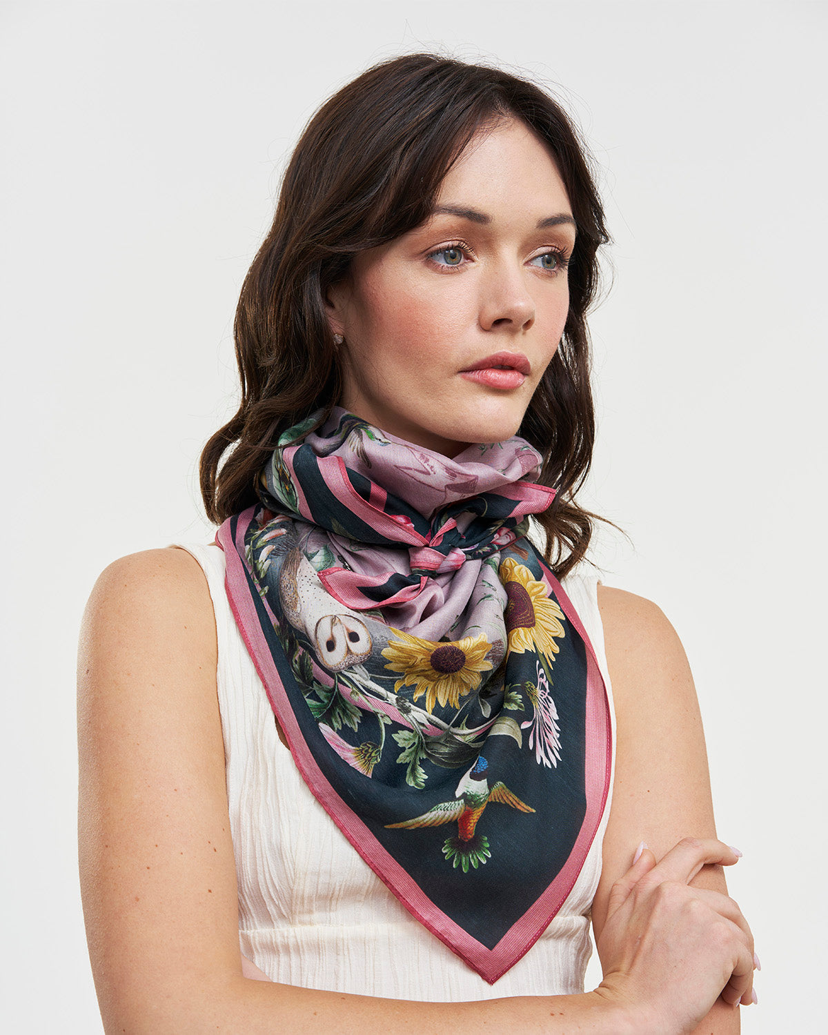 Model wearing floral square scarf around neck with white background