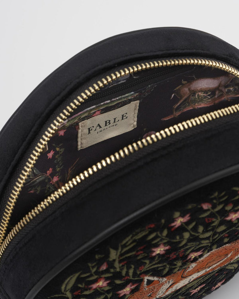 close up detail inside the embroidered sleepy fox motif on navy circle crossbody bag. Pretty Woodland print lining and internal zip.