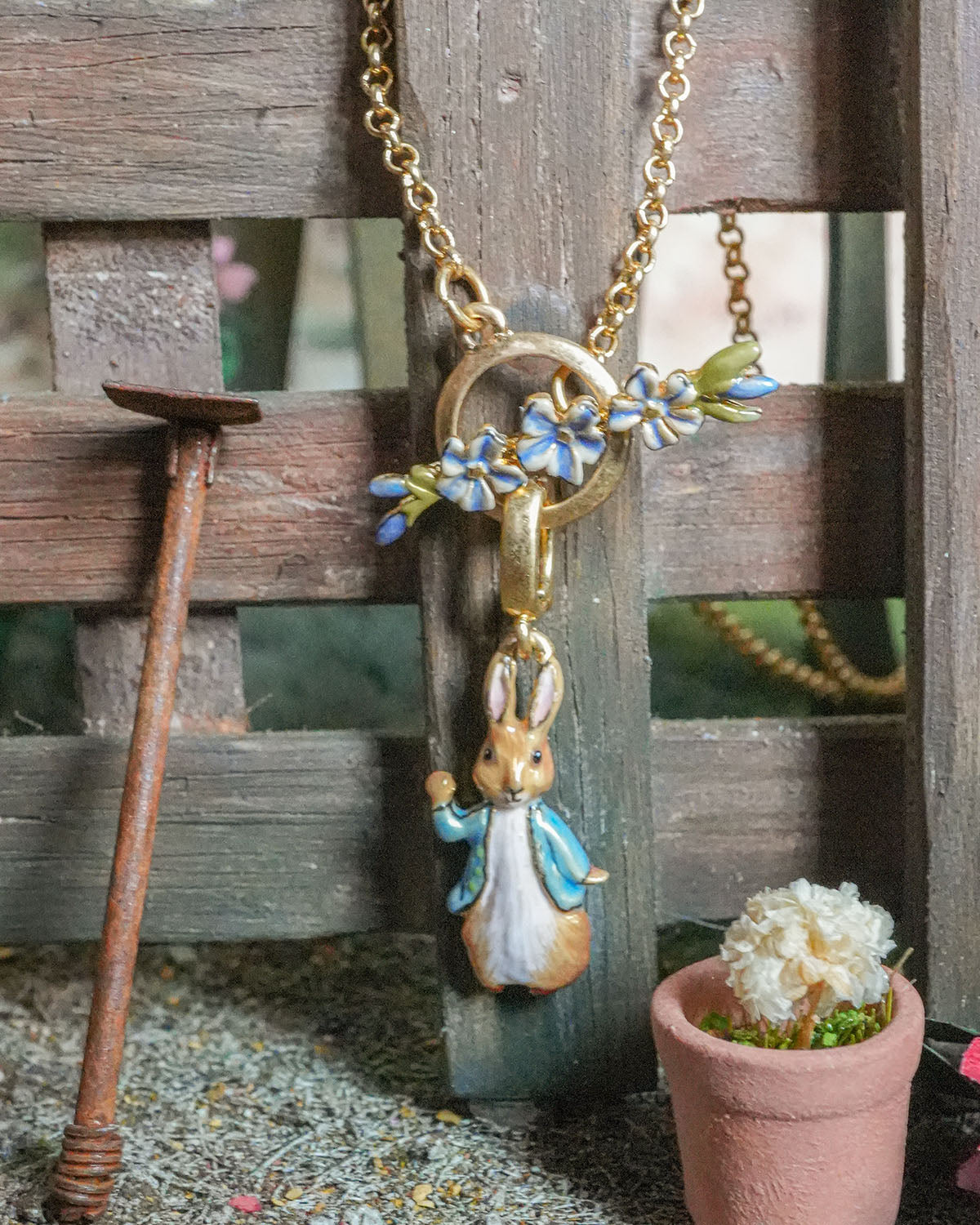 Necklace with a rabbit pendant and floral elements on a wooden background