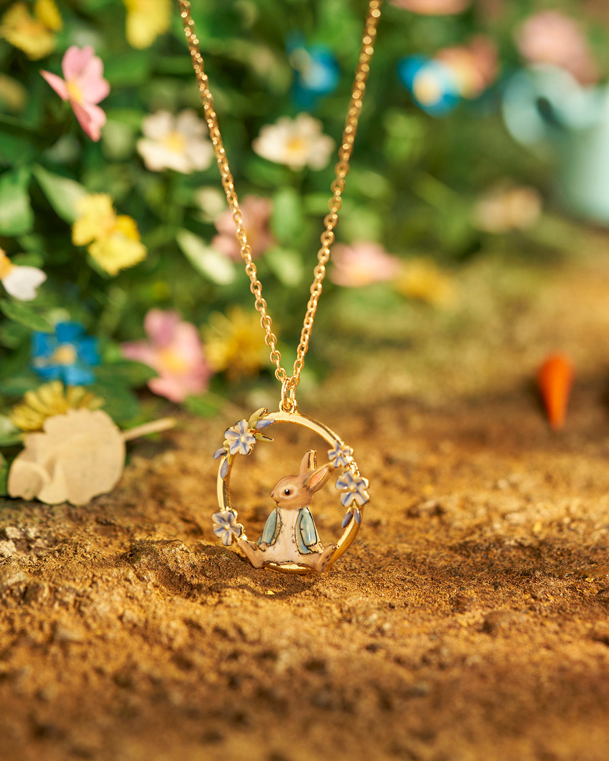 Gold necklace with a rabbit pendant on a natural background